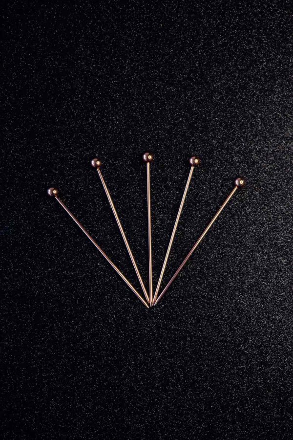 Exquisite cocktail sticks adorned with elegant pink pearls, perfect for stylish entertaining and adding a touch of luxury to drinks.
